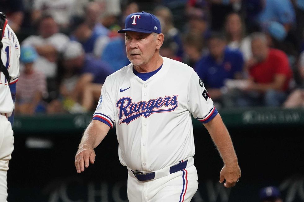 Texas Rangers manager Bruce Bochy (15) walks to the mound for a pitching change during the fourth inning against the Minnesota Twins at Globe Life Field.