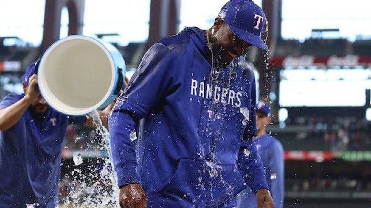 Texas Rangers relief pitcher Alex Speas (58) reacts after having water poured on him after the game against the Tampa Bay Rays at Globe Life Field