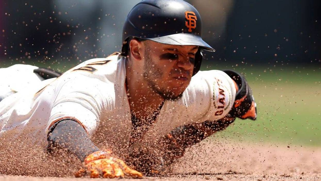 Thairo Estrada #39 of the San Francisco Giants slides in to third base for a triple that scored a run in the second inning against the Colorado Rockies at Oracle Park on June 09, 2022 in San Francisco, California.
