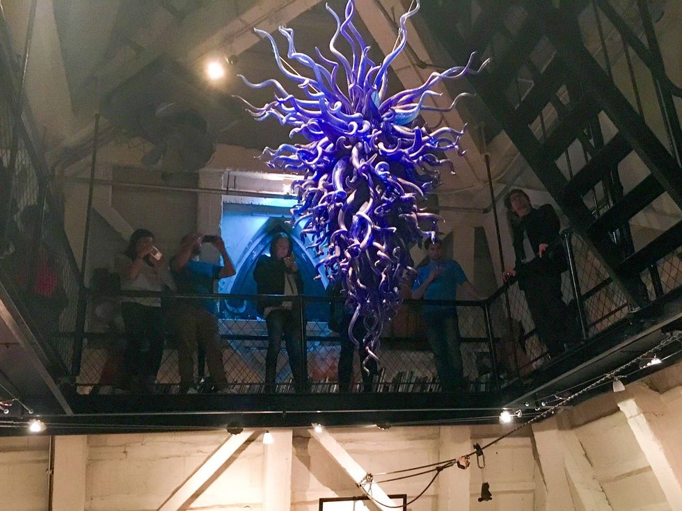 That gifted Chihuly chandelier, now packed and moved on, fills the otherwise oddly empty space in the penthouse apartment of the Smith Tower.
