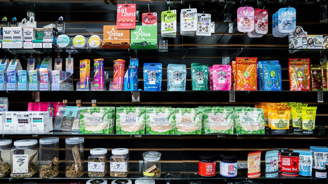 THC edibles are displayed on shelves at a smoke shop.