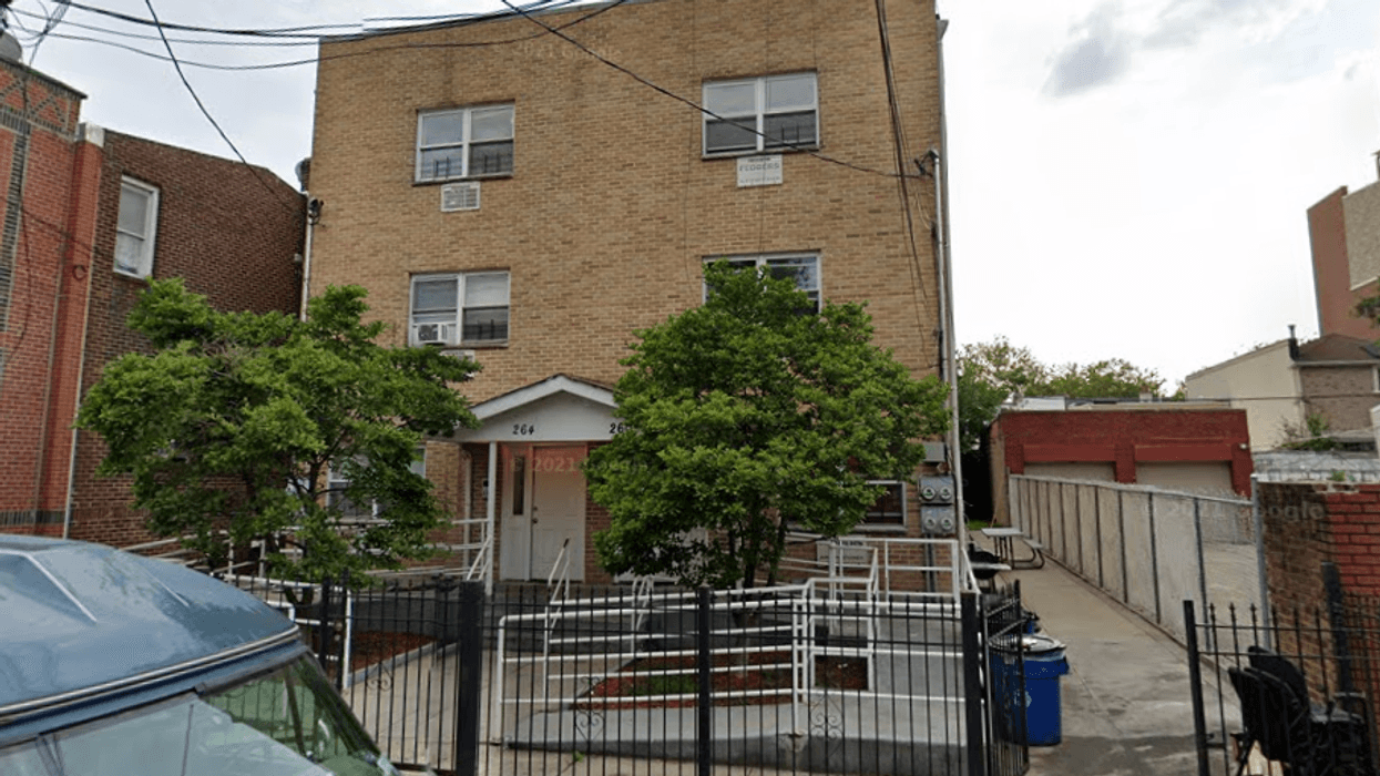 The apartment building where three people were shot Saturday night.