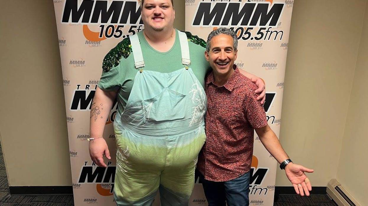 The artist TALK with Jonathan Suttin in front of Triple M banner