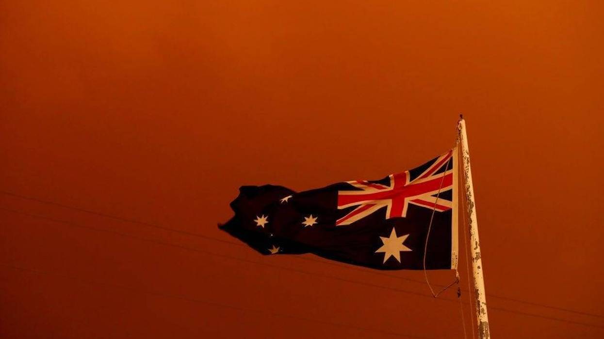 The Australia Flag flies under red skies from the fires on January 04, 2020 in Bruthen Australia.