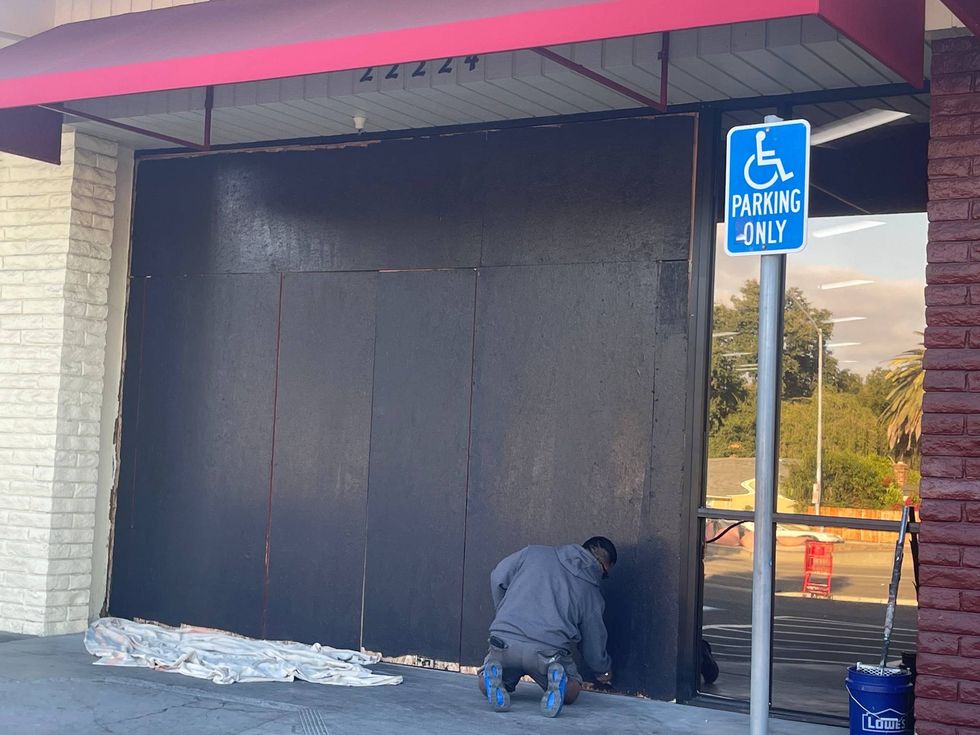 The boarded up storefront at the Trader Joe