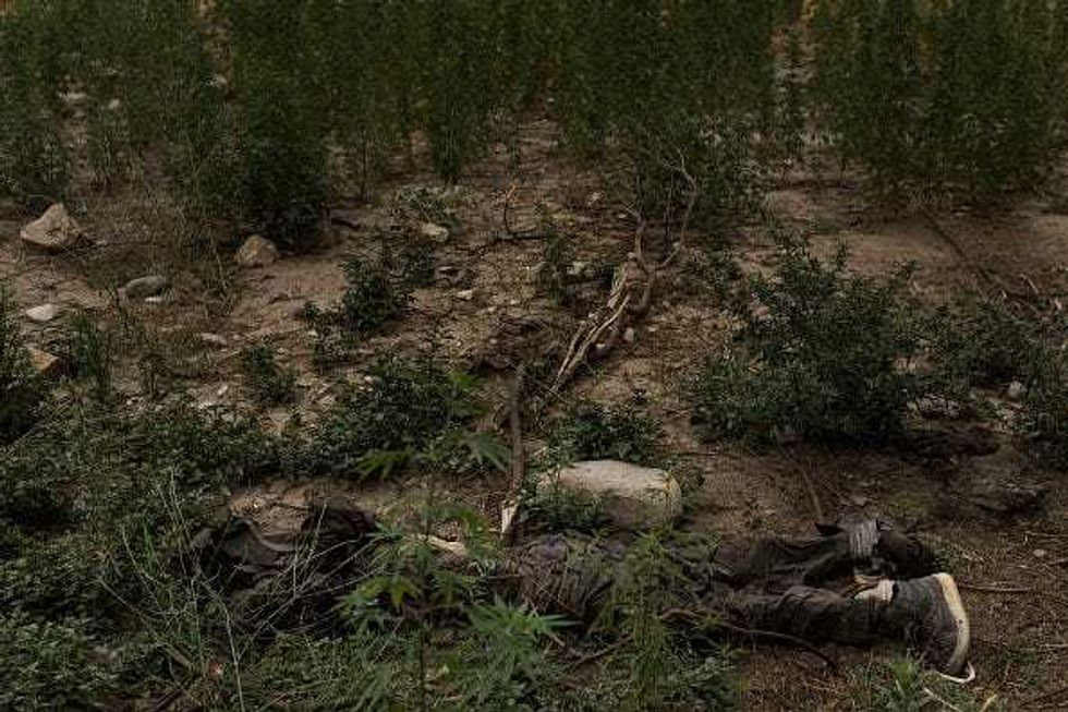 The body of an ISIS-K fighter killed by an airstrike lays on the ground a few hundred meters from where the GBU-43/B Massive Ordnance Air Blast, nicknamed the