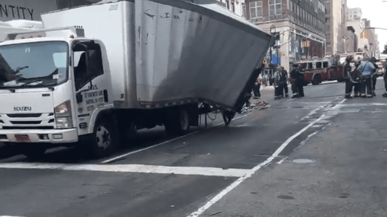 The box truck that hit the MTA bus was damaged in the crash.