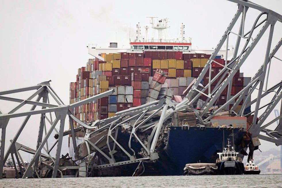 The cargo ship Dali is stuck under part of the structure of the Francis Scott Key Bridge in Baltimore after the ship hit the bridge on Tuesday.