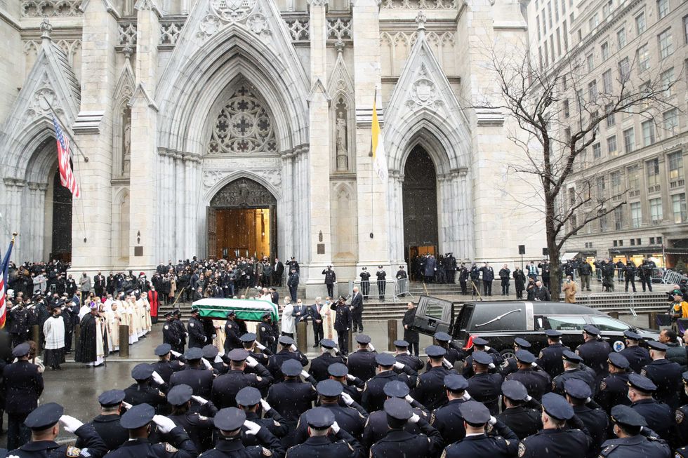 The casket of fallen NYPD Officer Jason Rivera is brought out of St. Patrick