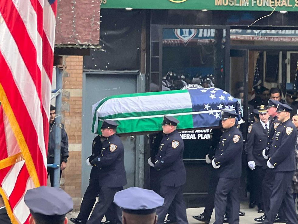 The casket of Officer Adeed Fayaz is carried during Thursday