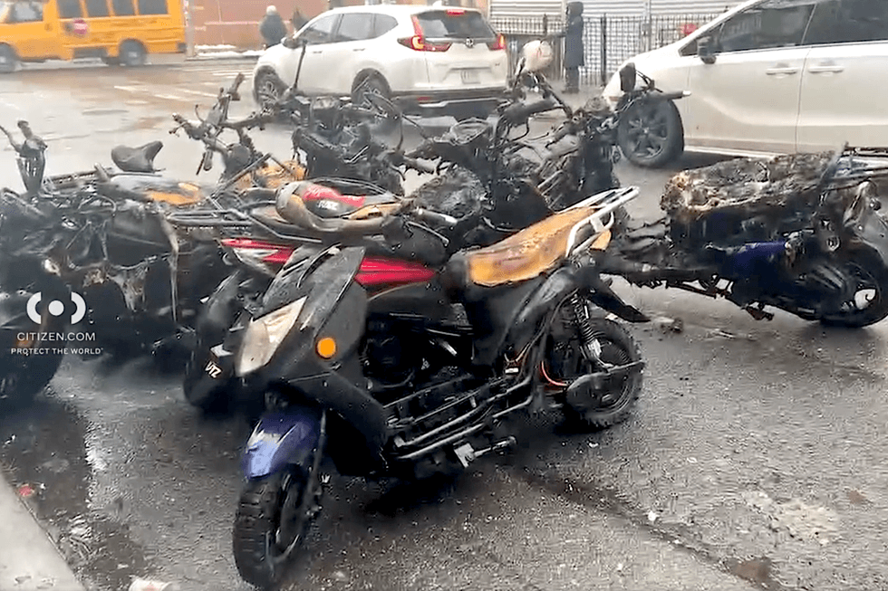 The charred remains of vehicles were gathered on the street outside