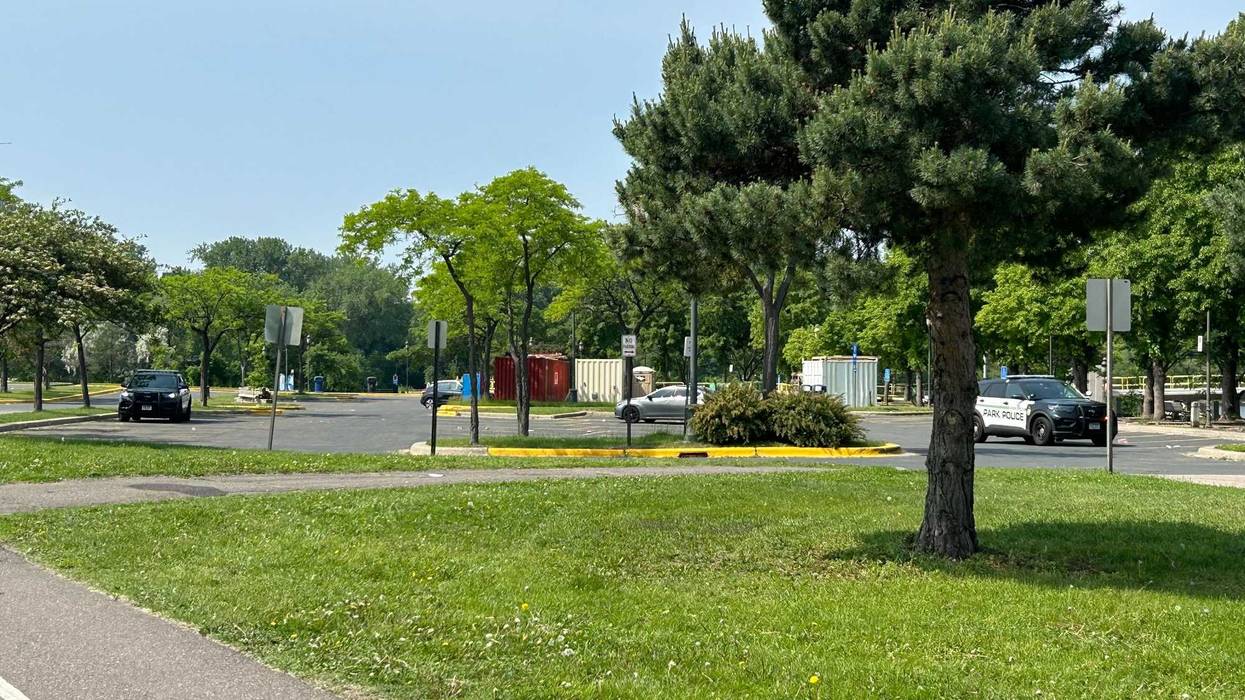 The closed off entrance to Boom Island Park where police are still processing a crime scene that left one woman dead and five men injured after a Sunday night shooting.