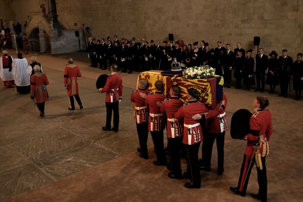 The coffin of Queen Elizabeth II is carried inside Westminster Hall in London, Wednesday, Sept. 14, 2022