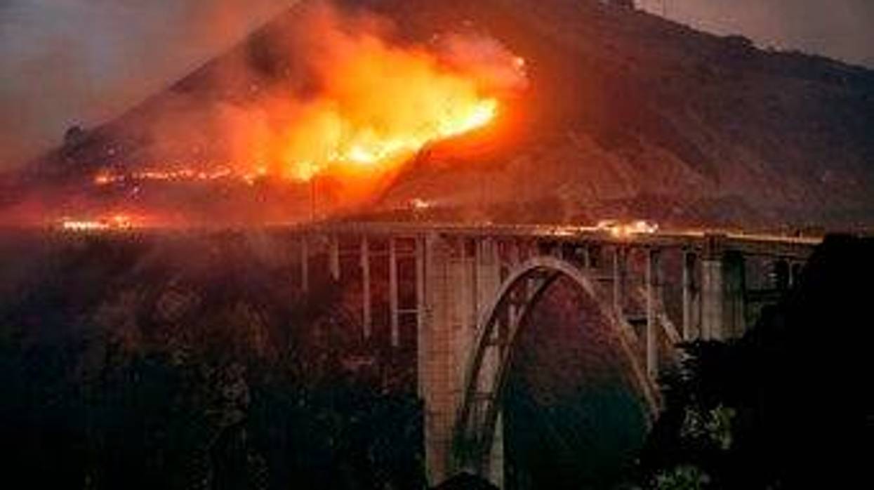 The Colorado Fire burns down toward the Bixby Bridge in Big Sur, Calif., early Saturday morning, Jan. 22, 2022.
