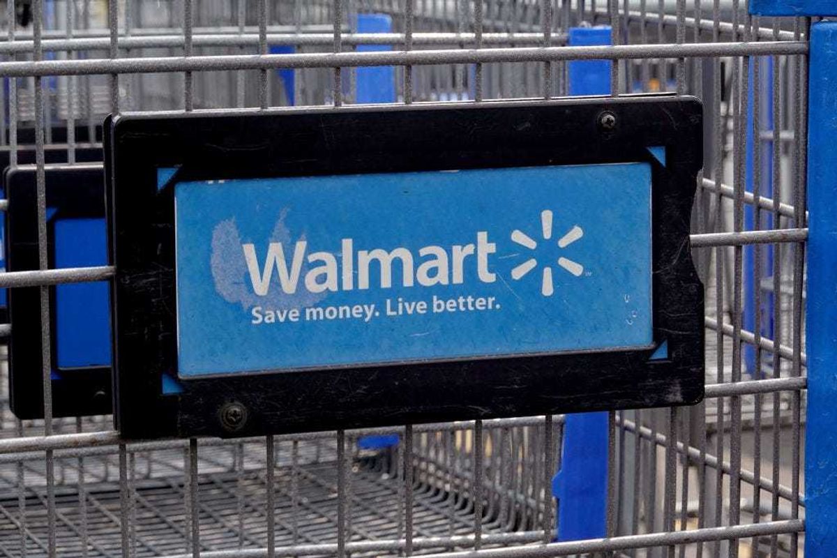 The company logo is shown on the front of shopping cart at a Walmart store on May 18, 2023 in Chicago, Illinois. Walmart, the world's largest retailer, today reported first-quarter same-store sales growth that beat expectations and the company raised its full-year forecast. (Photo by Scott Olson/Getty Images)