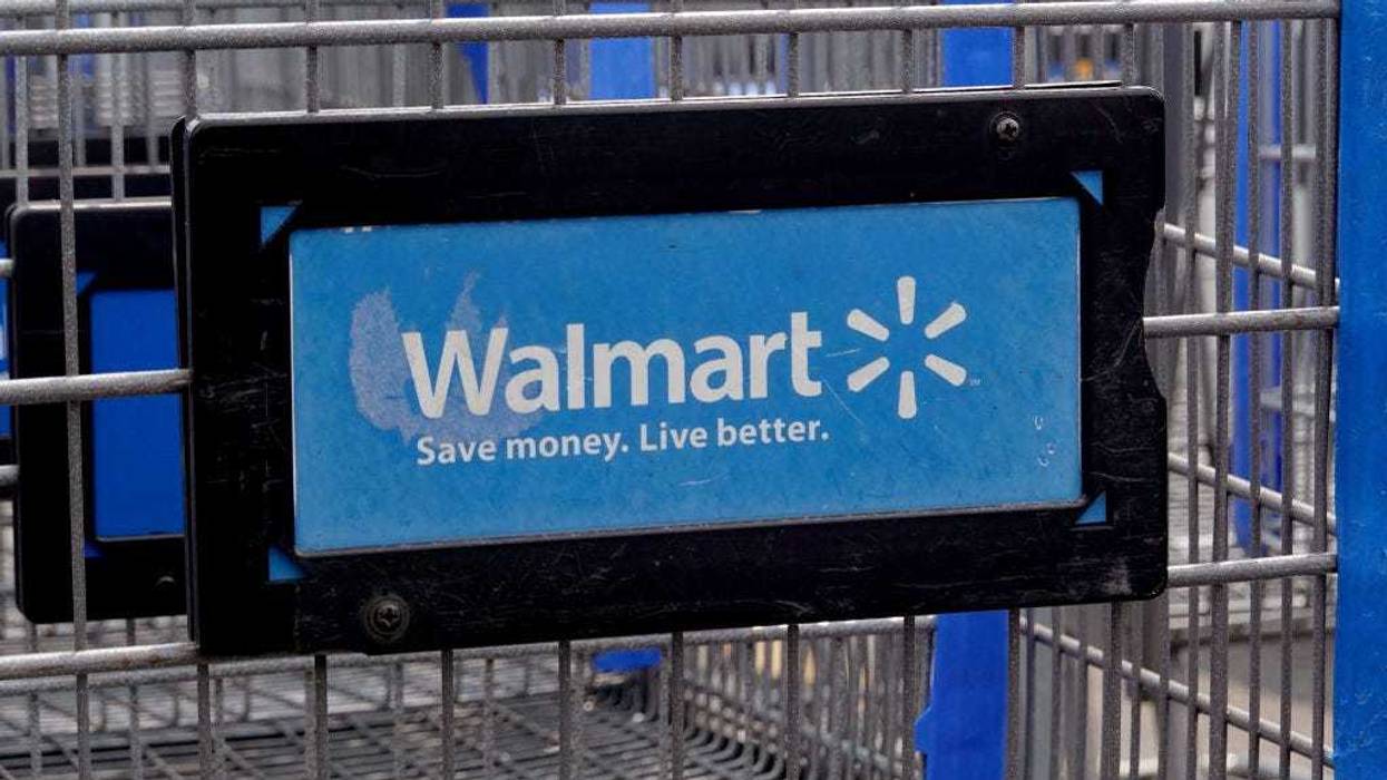 The company logo is shown on the front of shopping cart at a Walmart store on May 18, 2023 in Chicago, Illinois. Walmart, the world's largest retailer, today reported first-quarter same-store sales growth that beat expectations and the company raised its full-year forecast. (Photo by Scott Olson/Getty Images)