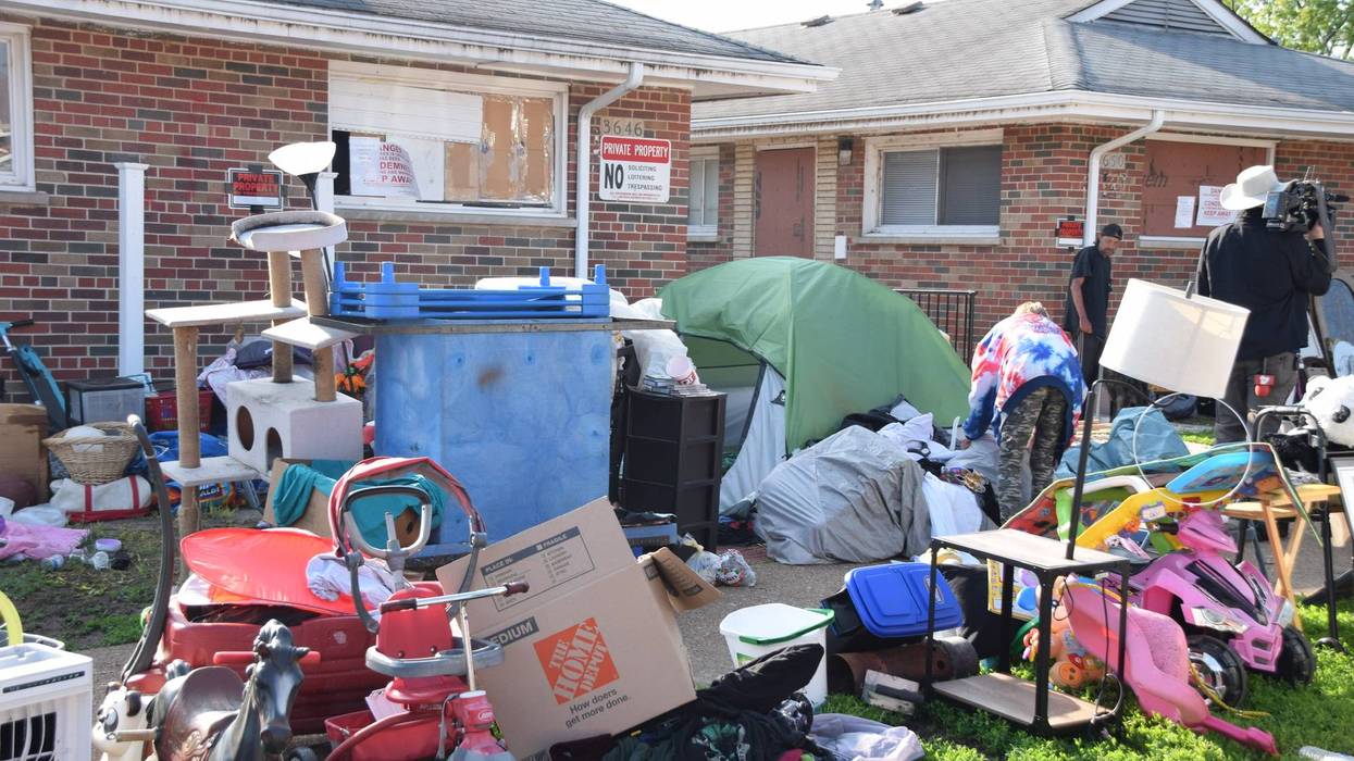 Clearing tents outside condemned apartments