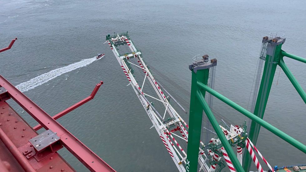 The container crane passes under the Golden Gate Bridge early Thursday.