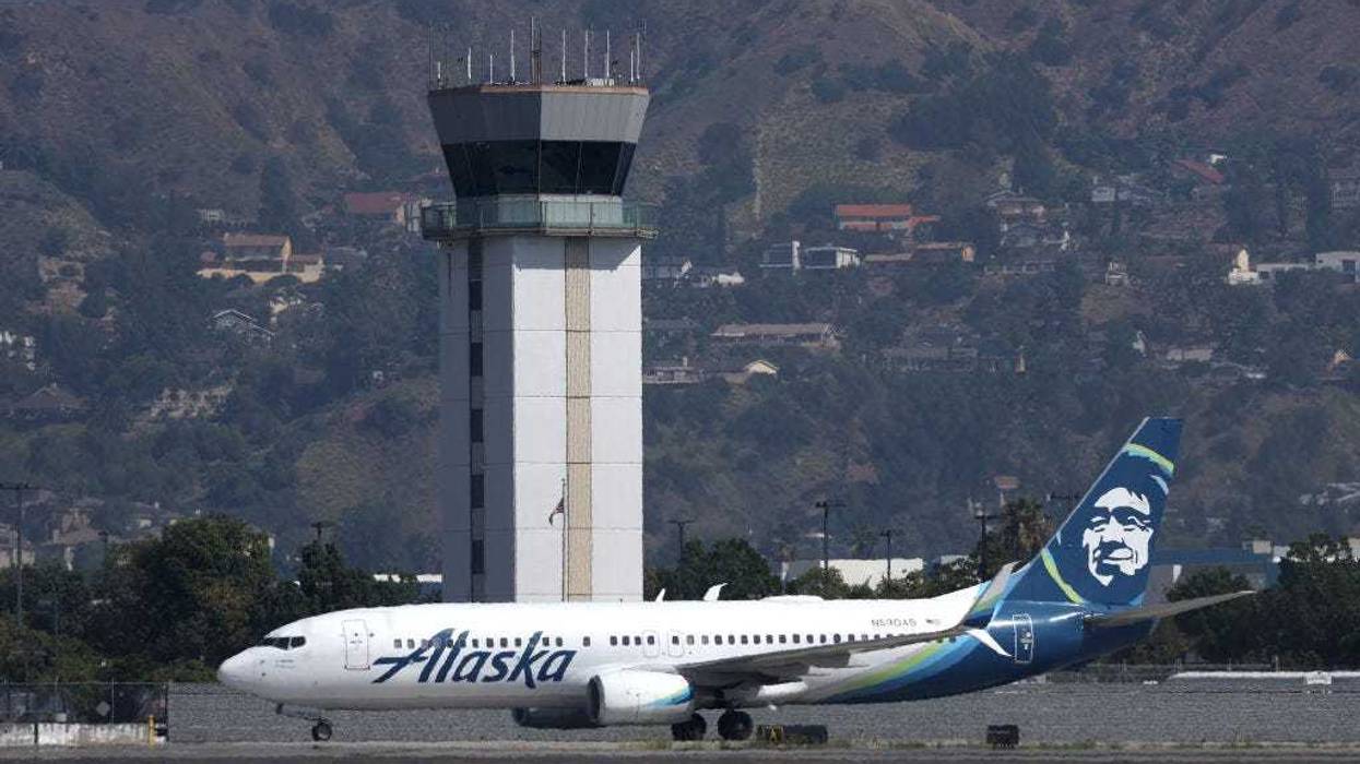 The control tower at Hollywood Burbank Airport stands over an Alaska Airlines plane as it taxis on September 25, 2023 in Burbank, California.