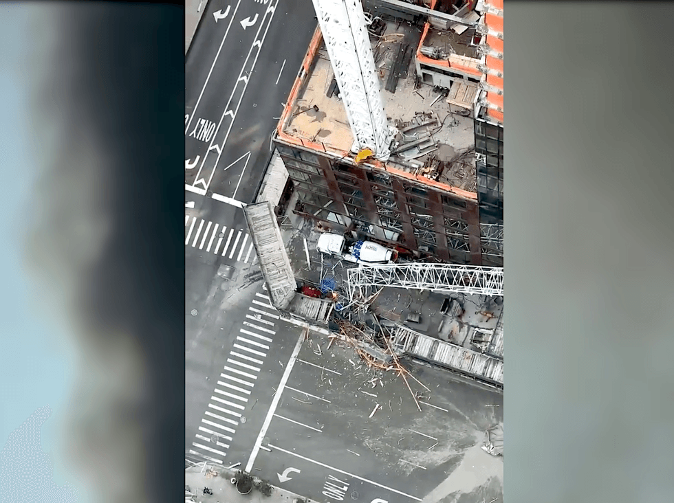 The crane arm crashed to the street below