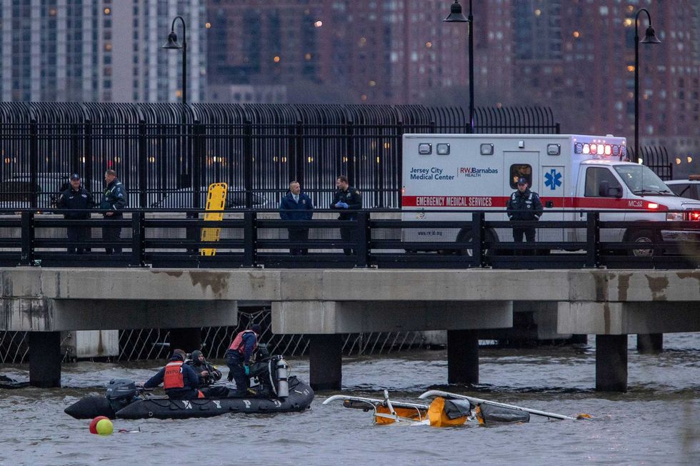 The crashed helicopter is seen in the Hudson River during recovery operations on April 10, 2025