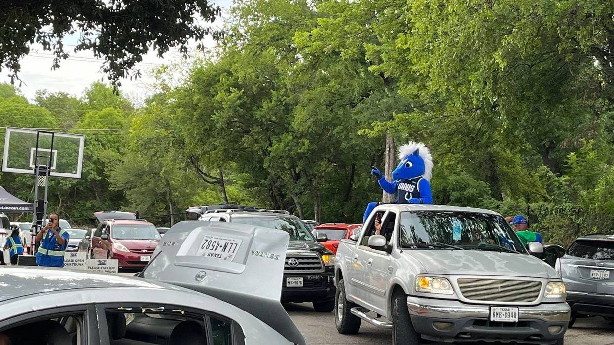 The Dallas Mavericks' mascot Champ helps hand out hydration kits on Tuesday, Aug. 1, 2023.