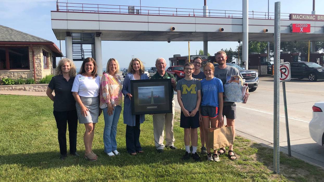 The Dalman family of Tawas City, far right, received a local gift basket and a framed print of the Mackinac Bridge after they drove the 200 millionth vehicle across the bridge. Left to right: MBA Chief Bridge Engineer Julie Neph; Mackinaw City Chamber of Commerce Executive Director Amy Millard; St. Ignace Visitors Bureau Executive Director Lora Brown; MBA Member Caroline Cheeseman; MBA Chairman Patrick “Shorty” Gleason; Seth Dalman; Anna Dalman; Teresa Dalman; and Kurt Dalman.