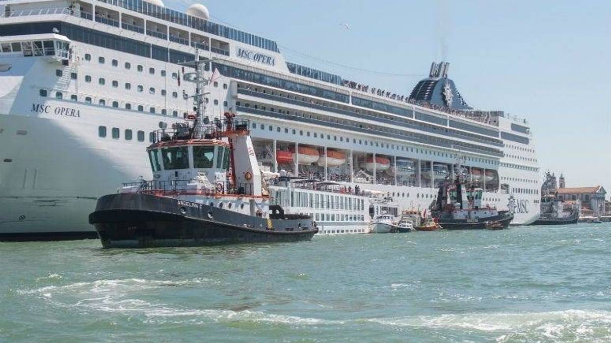 The damaged tourist river boat docked next to the cruise ship after Sunday's collision.
