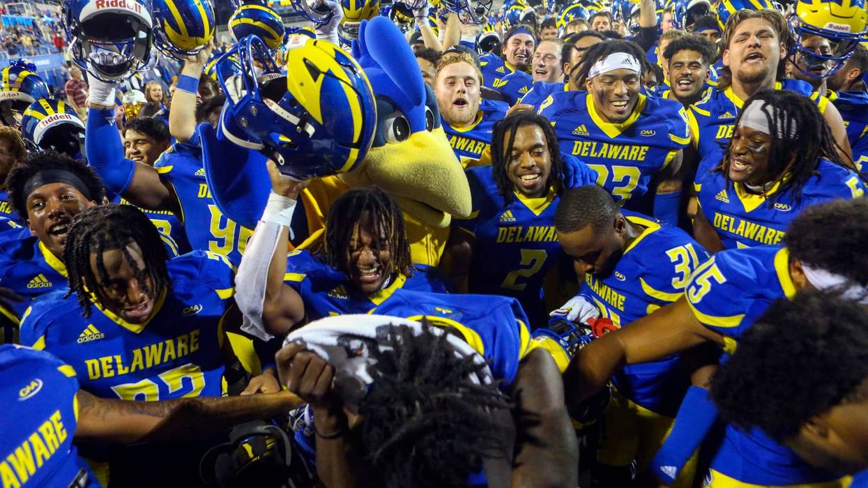 The Delaware Blue Hens gather in front of the University of Delaware Marching Band to celebrate the Hens' 35-9 win against Delaware State at Delaware Stadium on Saturday, Sept. 10, 2022.