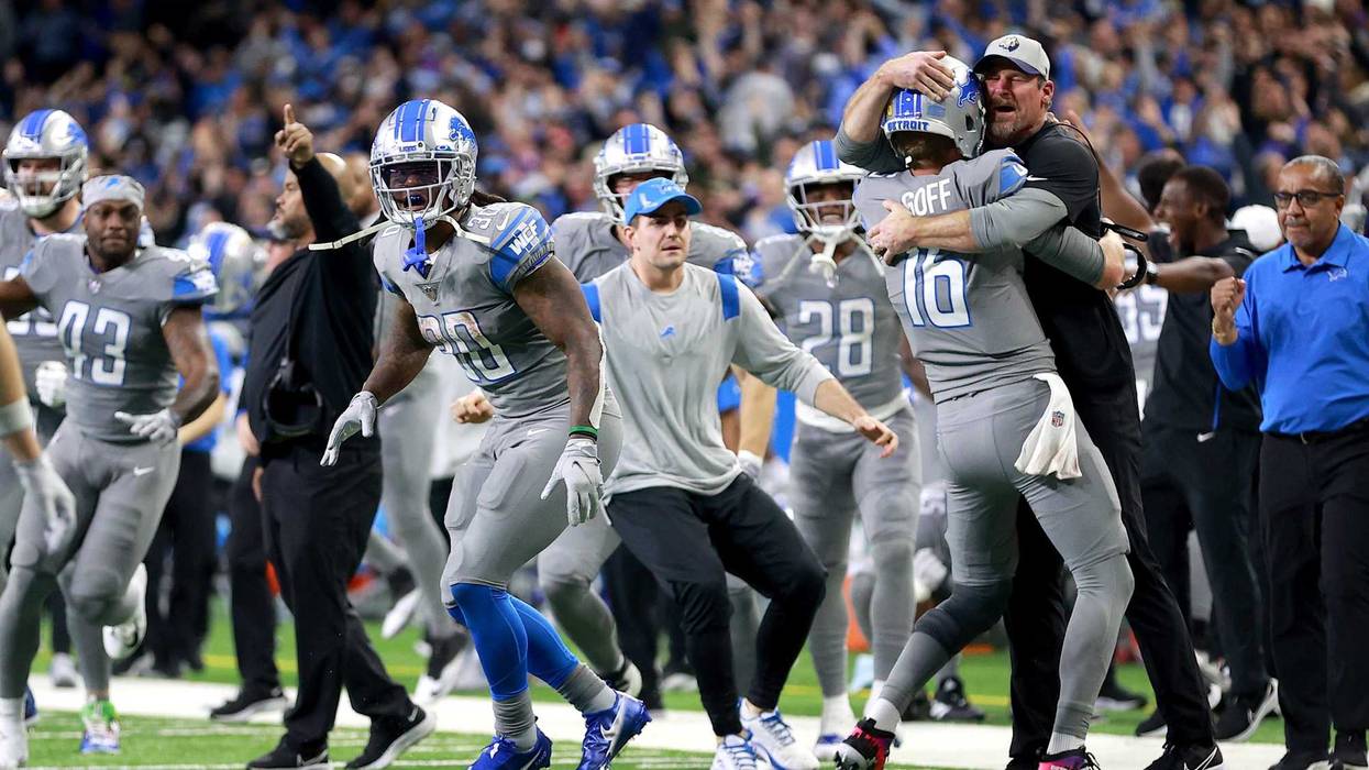 The Detroit Lions celebrate their first win of the season.