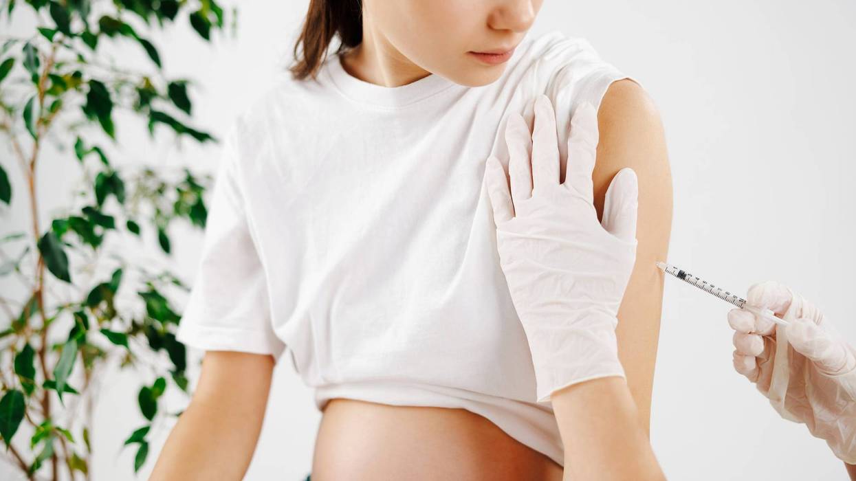 The doctor injects a pregnant girl. She came to the clinic to the gynecologist for an examination. High quality photo