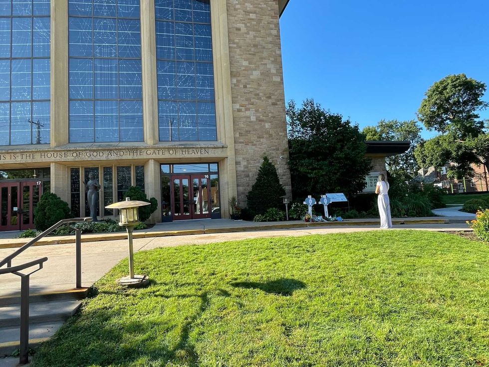 The early morning scene outside Annunciation Church on Thursday, a day after a gunman killed two and injured several others during a Catholic Mass.