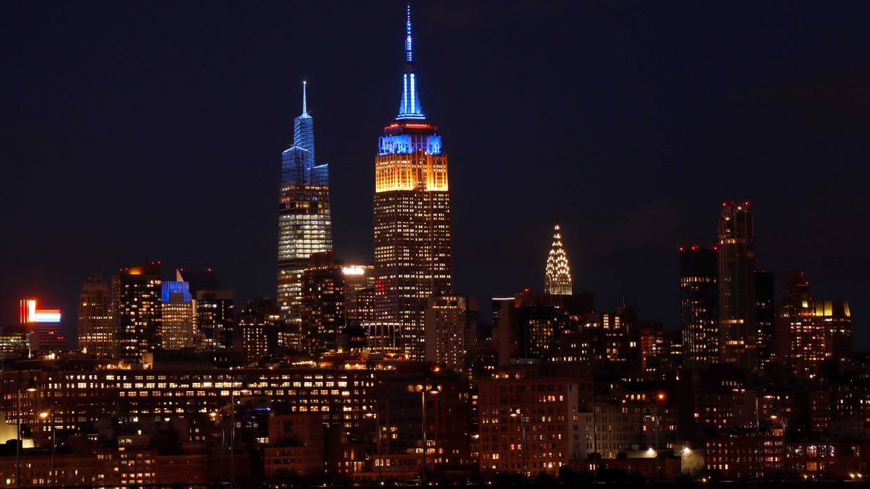 The Empire State Building is lit in the colors of the flag of Ukraine on Feb. 25, 2022, as seen from Jersey City