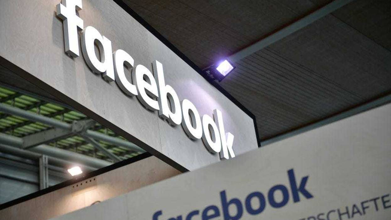 The Facebook logo is displayed at the 2018 CeBIT technology trade fair on June 12