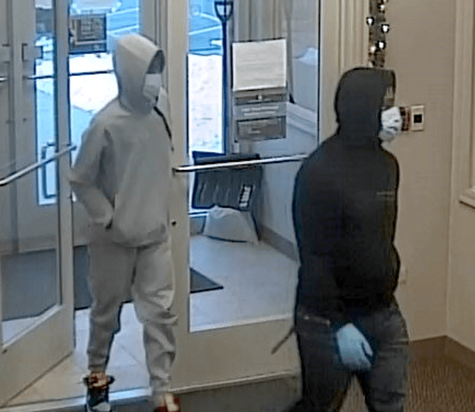The FBI says this pair is wanted for robbing three Chicago-area banks on Monday. This photo shows them at a Fifth Third Bank in Naperville.