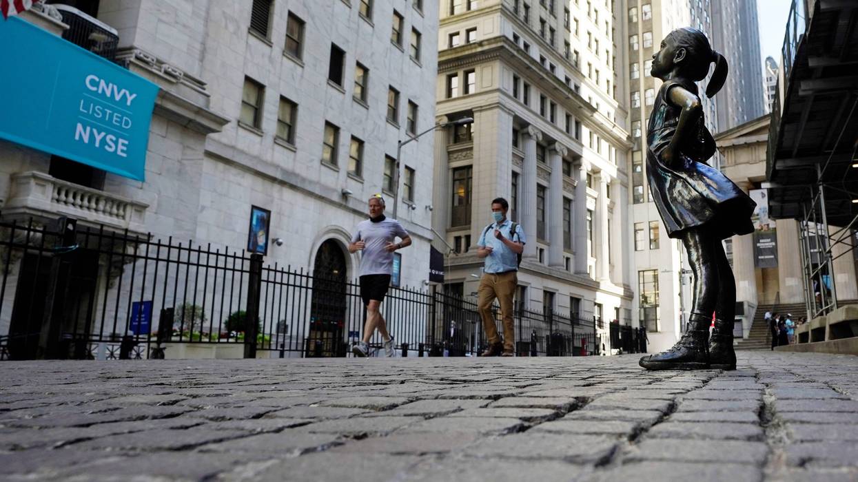The "Fearless Girl" statue faces the New York Stock Exchange, Wednesday, June 16, 2021. Stocks are opening broadly higher on Wall Street Friday, June 25 keeping the S&P 500 on track for its biggest weekly gain since April. (AP Photo/Richard Drew)