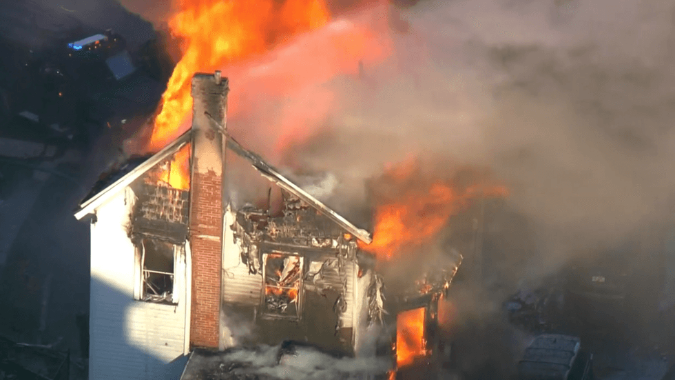 The fire tore through all three stories of the house.