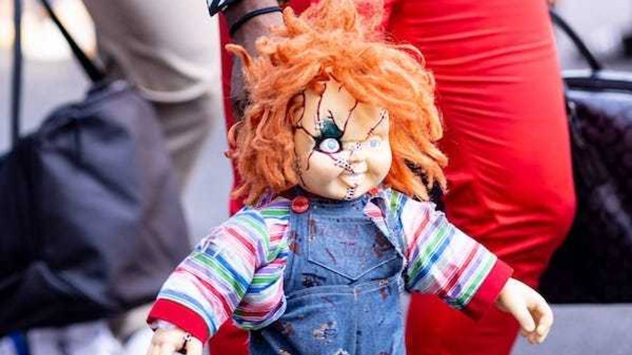 The Florida Gators hold a Chucky doll during Gator Walk