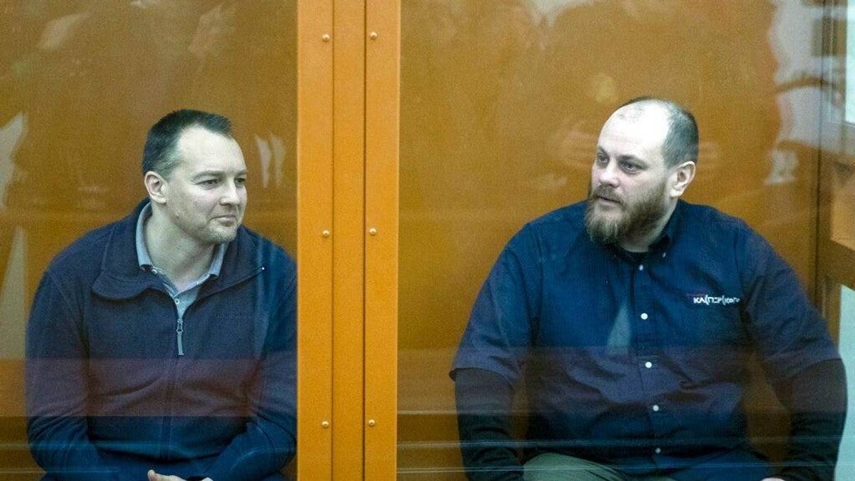 The former chief of the cybercrime department at Russia's main domestic security agency Sergei Mikhailov, left, and the former employee of Kaspersky Lab cybersecurity firm Ruslan Stoyanov attend a hearing in a court in Moscow, Russia, Tuesday, Feb. 26, 20
