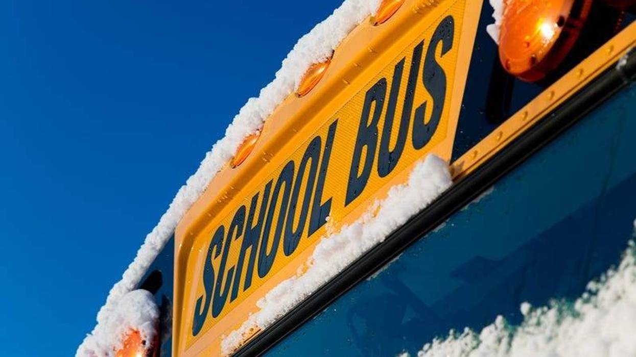 The front of a school bus after a fresh winter snowfall.