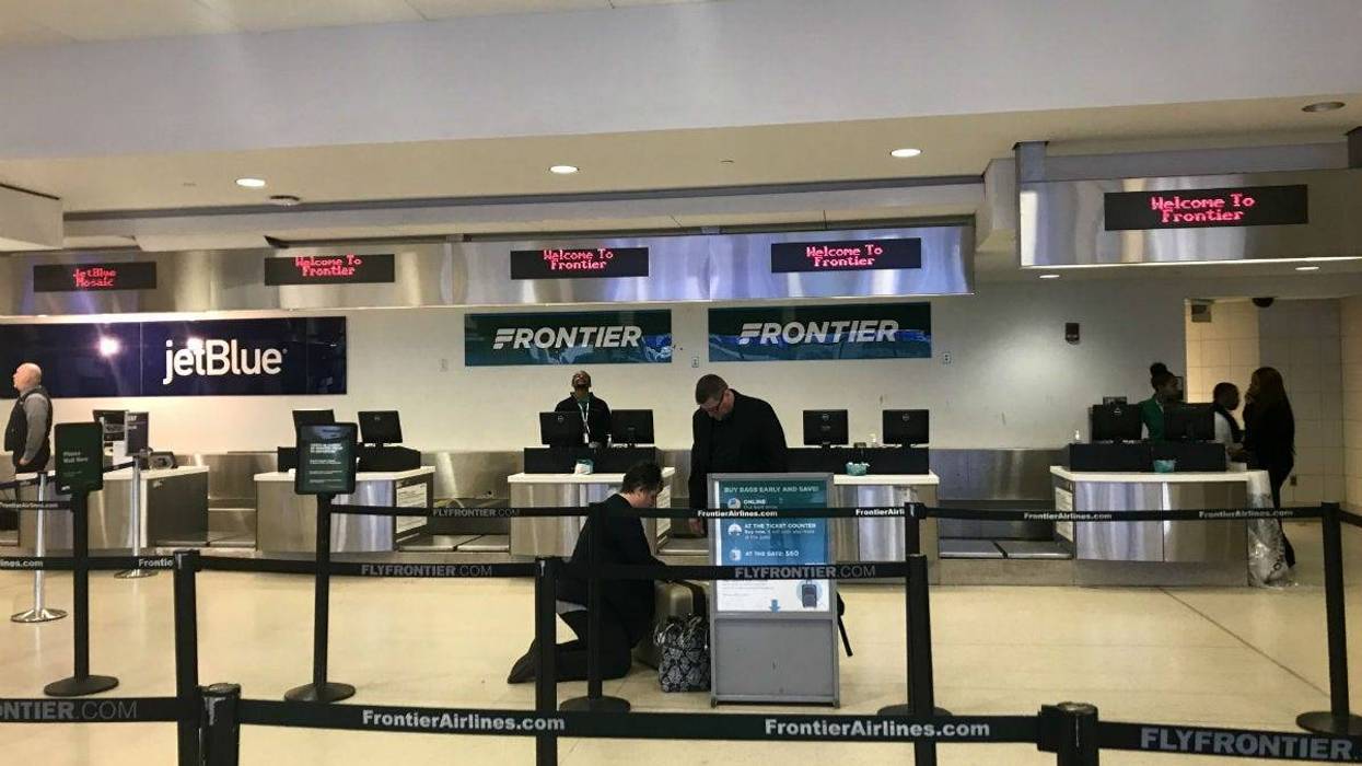 The Frontier Airlines check-in counter is shown at Philadelphia International Airport.