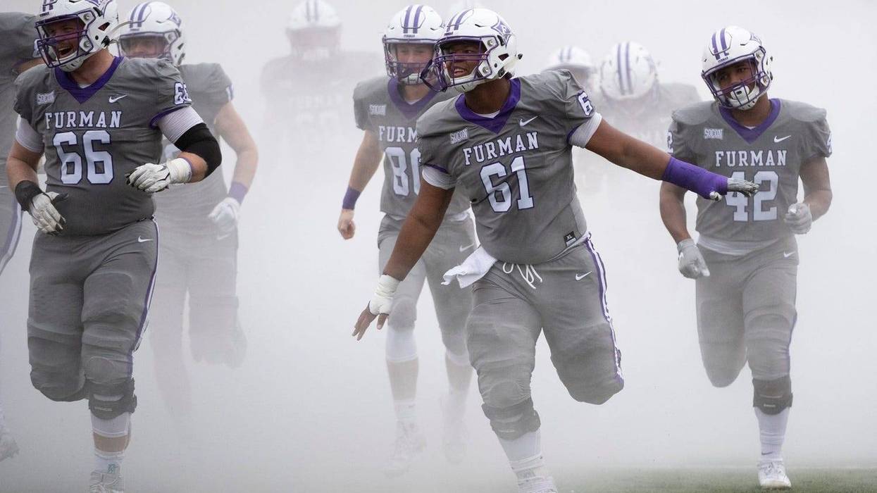 The Furman University football team runs onto the field before the game against Point University at Paladin Stadium Saturday, Nov. 23, 2019.