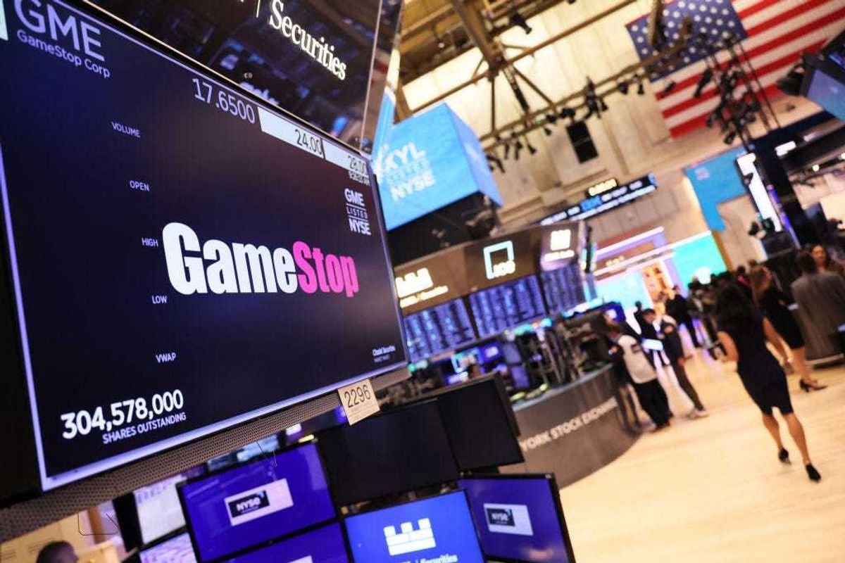 The Gamestop company logo is displayed on a screen as traders work on the floor of the New York Stock Exchange during morning trading on March 22, 2023 in New York City.