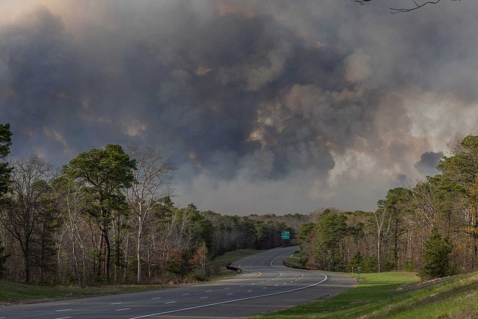 The Garden State Parkway North closed from Barnegat northward toward Lacey with fire in background. April 22, 2025