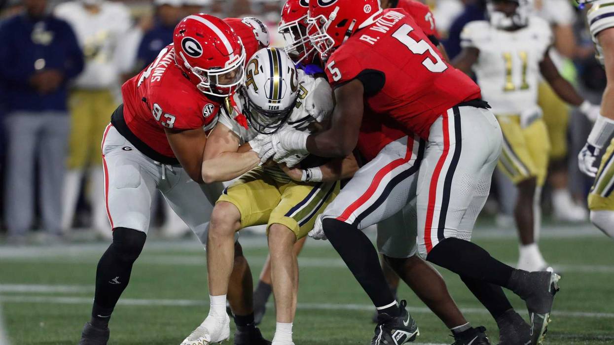 The Georgia defense stops Georgia Tech quarterback Haynes King (10) during the second half of a NCAA college football game against Georgia Tech in Atlanta, on Saturday, Nov. 25, 2023.Georgia won 31-23.