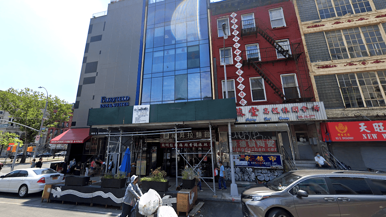 The glass building is where federal officials the men allegedly operated out of 107 East Broadway.