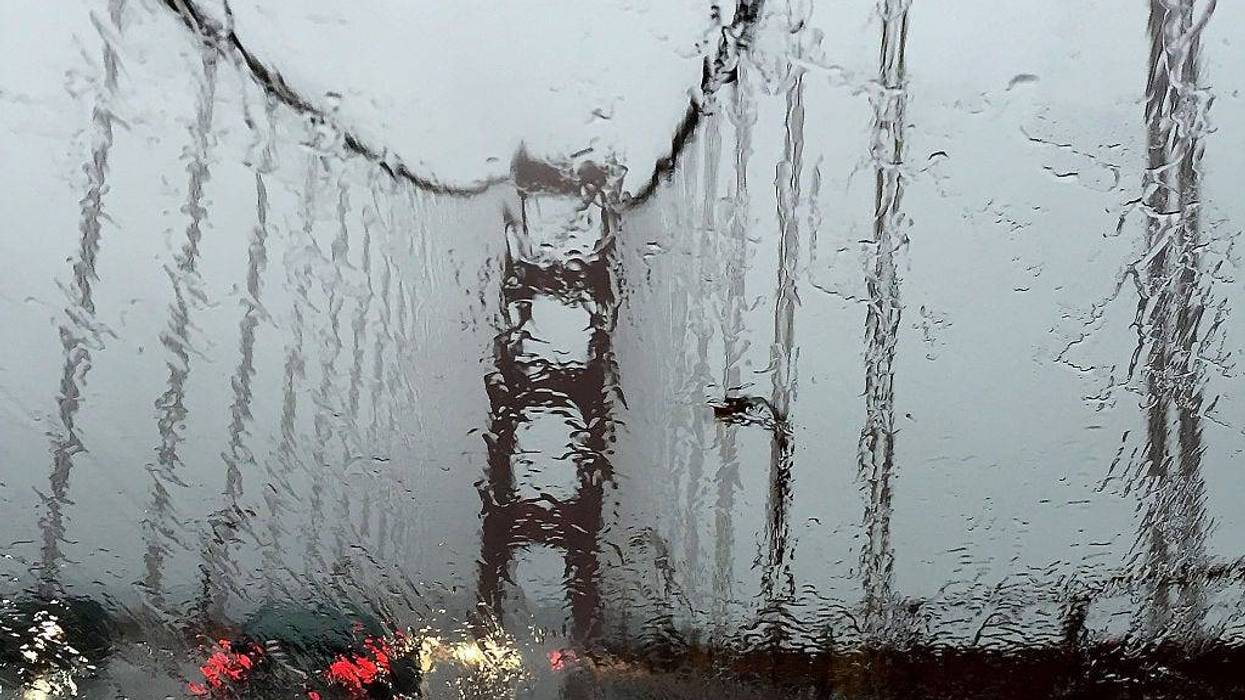 The Golden Gate Bridge is seen through a rain covered windshield on December 11, 2014 in Larkspur, California.