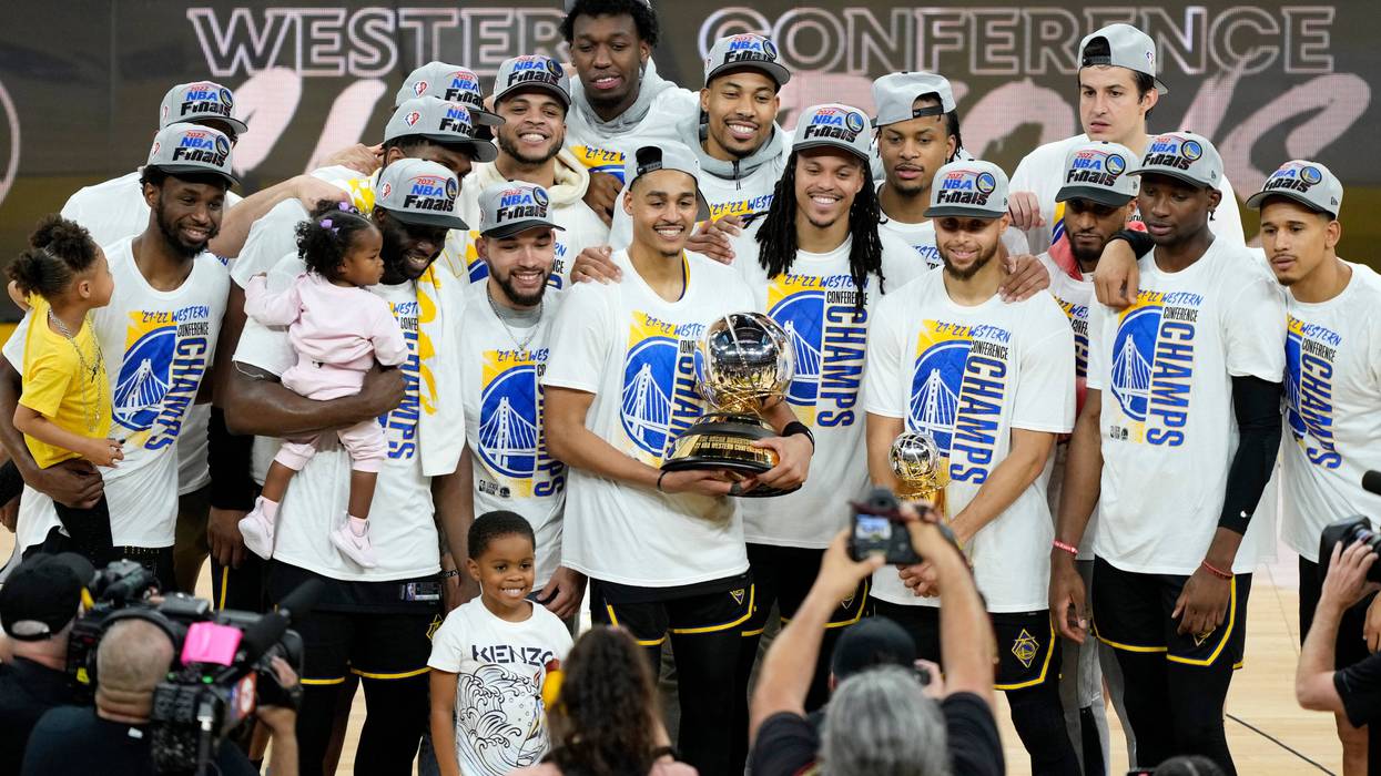 The Golden State Warriors hold the Western Conference Champion trophy after the 120-110 win against the Dallas Mavericks in Game Five of the 2022 NBA Playoffs Western Conference Finals at Chase Center on May 26, 2022 in San Francisco, California.