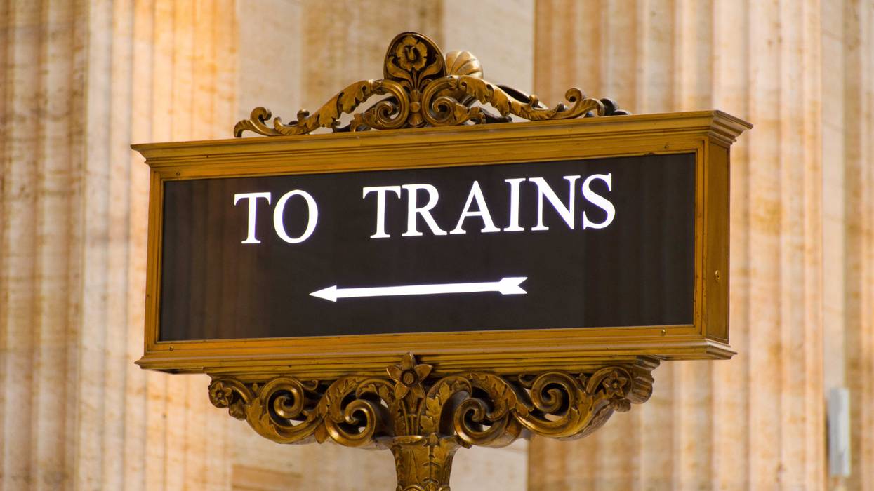 The Great Hall of Chicago's Union Station showing close-up of illuminated floor sign To Trains and large pillars in background