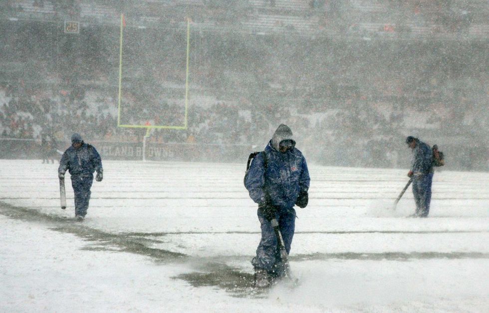 The grounds crew at Cleveland Browns stadium clear the yard markers during the NFL football game as the Browns play the Buffalo Bills, Sunday, December 16, 2007, in Cleveland.